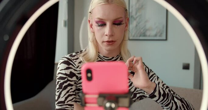 Transgender blond man streaming a live video at home