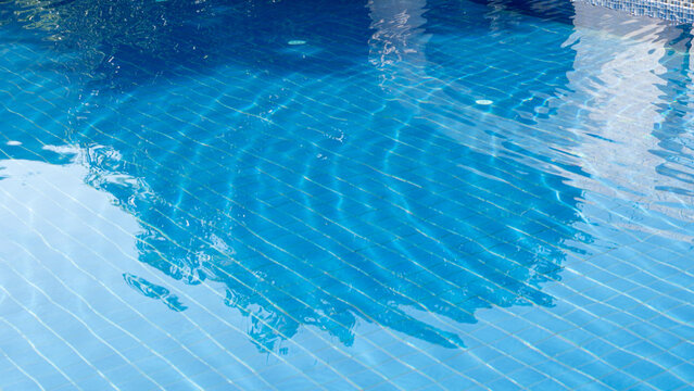 Clear water with gentle waves. Along with beautiful blue swimming pool floor tiles.