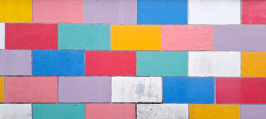 COLOURFUL WALL TILES DESIGN. Grunge style abstract background with a geometric design. brick wall painted in rainbow colors
