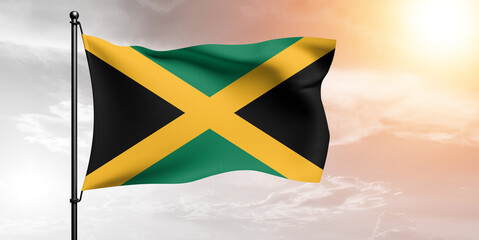 Jamaica national flag cloth fabric waving on beautiful sky grey Background.