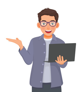 Young businessman with glasses using laptop showing hand for copy space