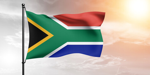 South Africa national flag cloth fabric waving on beautiful sky grey Background.