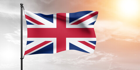 United Kingdom. national flag cloth fabric waving on beautiful sky grey Background.