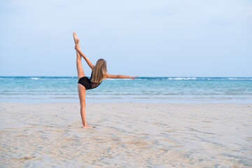 girl gymnast makes an element of rhythmic gymnastics, twine, stretching
