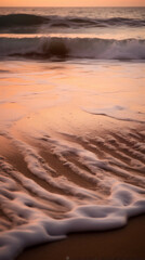 Closeup of the waves on the beach by the coast

