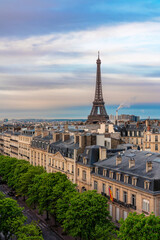 Eifel Tower against colorful sky and old town building in Paris, France. View from the roof top