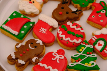 Fototapeta na wymiar tasty Christmas cookies on a white ceramic plate. delicious colorful Christmas cookies. kue kering natal.