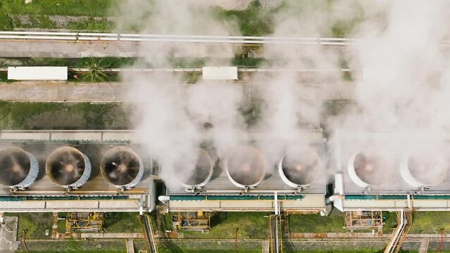Aerial drone of geothermal power plant with smoking pipes and steam. Renewable energy production at a power station. Negros, Philippines. Generative AI