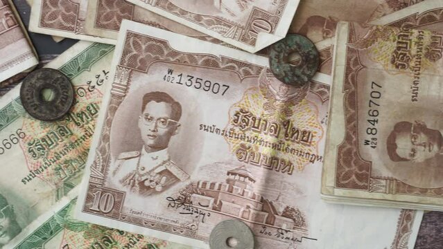 Pan shot Collection thai baht moeny banknote and coin of Thailand for collector on wood background