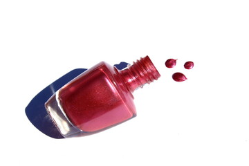 Burgundy nail polish pouring out of a bottle.	