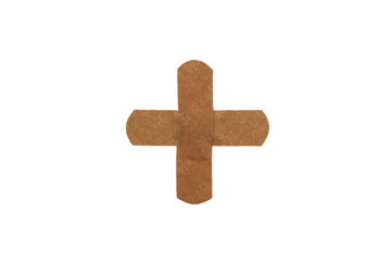 On a white isolated background there is an adhesive plaster in the form of a cross.