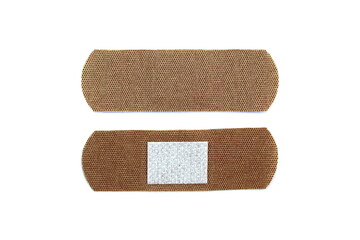 There are two adhesive plasters on a white background.