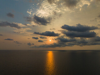 Aerial drone view of beautiful sunset with the ocean of Gulf of Thailand. Kood island, Thailand.