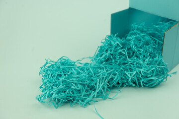 Blue box with blue shredded paper packing material for your product placement