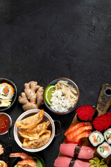 Traditional Japanese food dishes on black background, top view, copy space