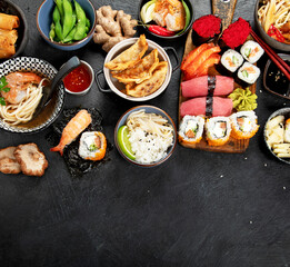 Traditional Japanese food dishes on black background, top view, copy space