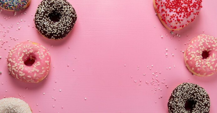 Tasty donuts on pink background. National donuts day.