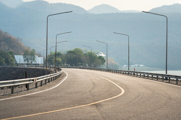 Roadside metal rail barrier structure which is installed on side of the road for protected the car accident. Transportation safety equipment object, selective focus. © Nattawit