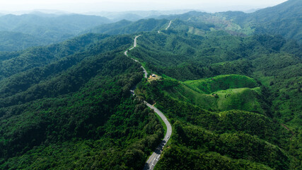 Fototapeta na wymiar aerial view ROAD No.1081 or shape number three of winding mountain road between Pua District, Nan Province, Thailand is highlight point and landmark that tourist like to take pictures 