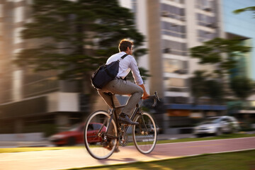 Fototapeta Fast, bicycle and business man in city for morning, commute and carbon neutral transportation. Travel, sustainability and cycling with male employee in urban town for motion blur, speed Generative AI obraz