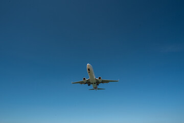 Fototapeta na wymiar Airplane flying at sky, Airliner passing blue sky