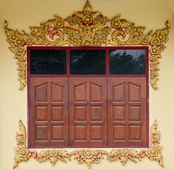 Gold Wood craft Thai classic pattern in temple With reflection of leaves at Thailand.