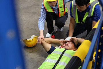 Safety colleagues team helping middle aged warehouse asian worker who had broken head accident and...