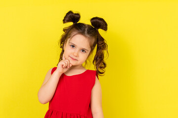 Little girl thinking on a white background. Closeup of a dreaming beautiful little girl