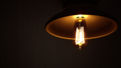 Glowing lighting bulb with classic style lamp on dark background. Generative Ai image.