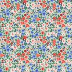 Seamless pattern. Vector flower design with cute wildflowers. Romantic abstract floral pattern on a light green background. Illustrations of spring nature in bright red and blue tones.