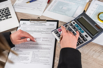 business woman filling blank 1040 individual income tax return form