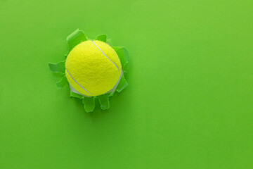 tennis ball on torn paper