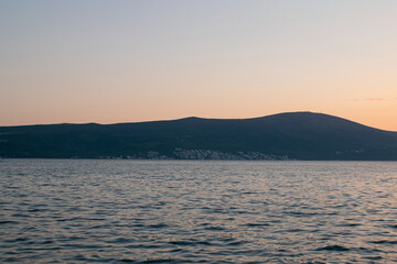 Beautiful sunset over coastal hills and sea. Nature concept.