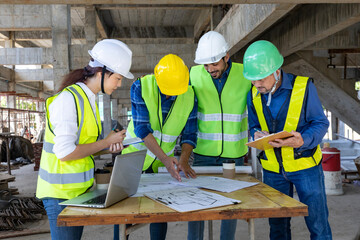 Team of engineer, architect, contractor and foreman meeting and consulting at construction building site with floor plan for real estate development project industry and housing timeline