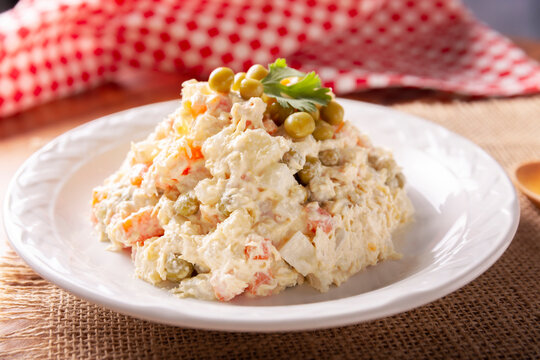 Russian Salad, also known as Olivier Salad. Very popular dish in several countries, the main ingredients are commonly potatoes, mayonnaise and vegetables such as peas, carrots, boiled eggs or chicken