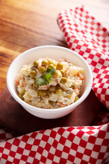 Russian Salad, also known as Olivier Salad. Very popular dish in several countries, the main ingredients are commonly potatoes, mayonnaise and vegetables such as peas, carrots, boiled eggs or chicken