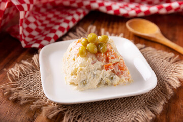 Russian Salad, also known as Olivier Salad. Very popular dish in several countries, the main ingredients are commonly potatoes, mayonnaise and vegetables such as peas, carrots, boiled eggs or chicken