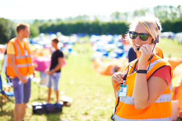 Festival security, communication and a woman outdoor 