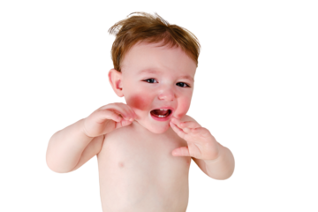 Crying screaming toddler baby boy is lying on the bed, isolated on a white background. Unhappy child close-up on a white blanket, isolated on a white background. Kid aged one year