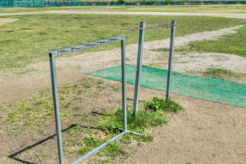 Aluminum baseball racks at urban public park.