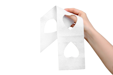A woman's hand holds toilet paper with cut-out hearts, isolated on a white background