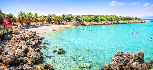 Emerald water and rocky beach at Cleopatra Island, Sedir Island, Aegean Sea, Marmaris, Turkey