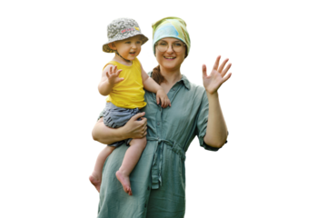 Mother holds a happy toddler baby boy in her arms and waves her hand, isolated on a white background. Smiling child with mom doing hello or bye gesture. Kid age one year