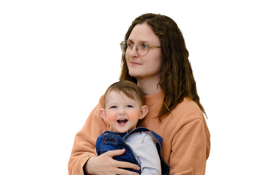 Happy toddler baby boy sits with woman mother, isolated on a white background. Kid age one year