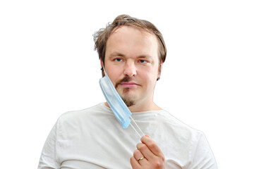 The man removes the medical mask under which the half-shaved beard and disheveled hair, isolated on...