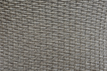 Closeup of gray woven rattan background with natural patterns