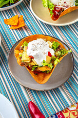 Traditional mexican food. Taco salad of veal, cheese, tomatoes, cheese and nachos. Colorful Food Table Celebration Delicious Party Meal Concept. 