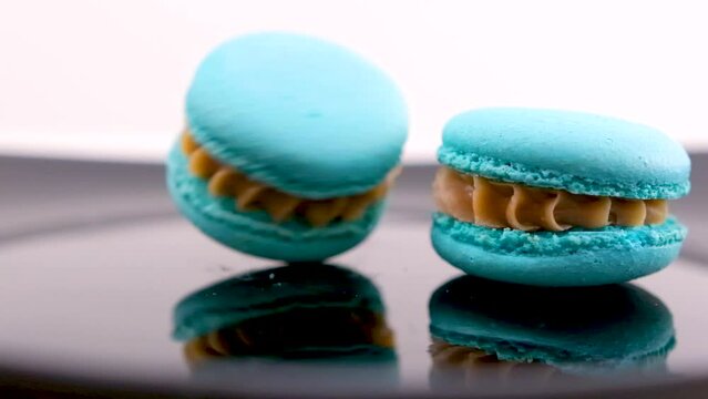 swirling blue macaron lavender or bru cheese flavor on black plate swirling delicious dessert restaurant serving sweetness french dessert lunch chef dish Generative AI