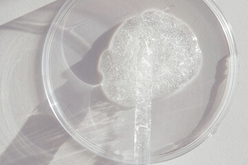 Pipette with Sample of Gels Cosmetic Product in Petri Dish on white background