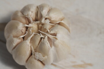 garlic on a white wooden table. Garlic is used as a spice in cooking in Europe, Asia, America, Africa and Australia. Allium sativum